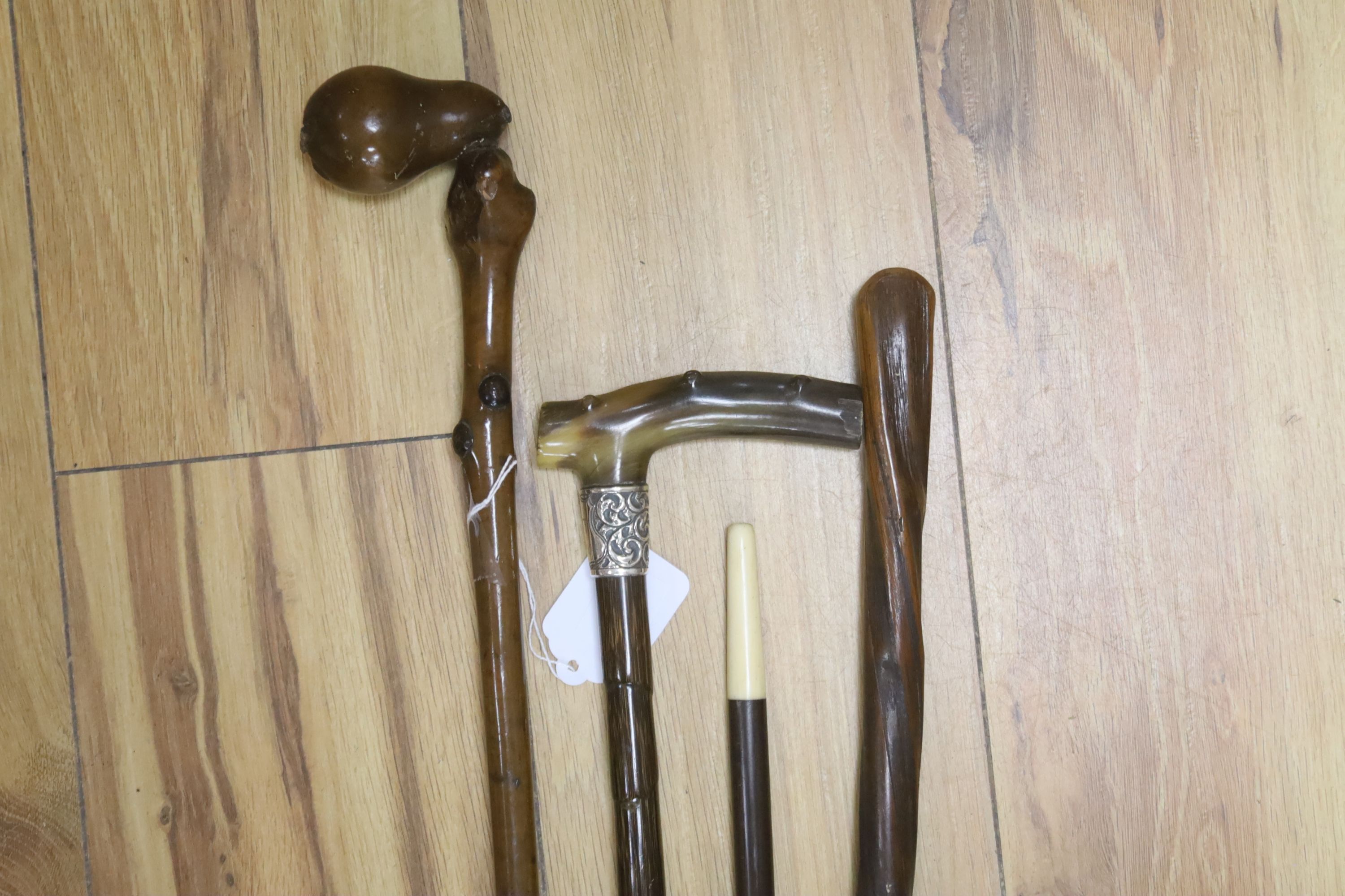 Four walking sticks, one horn and silver mounted